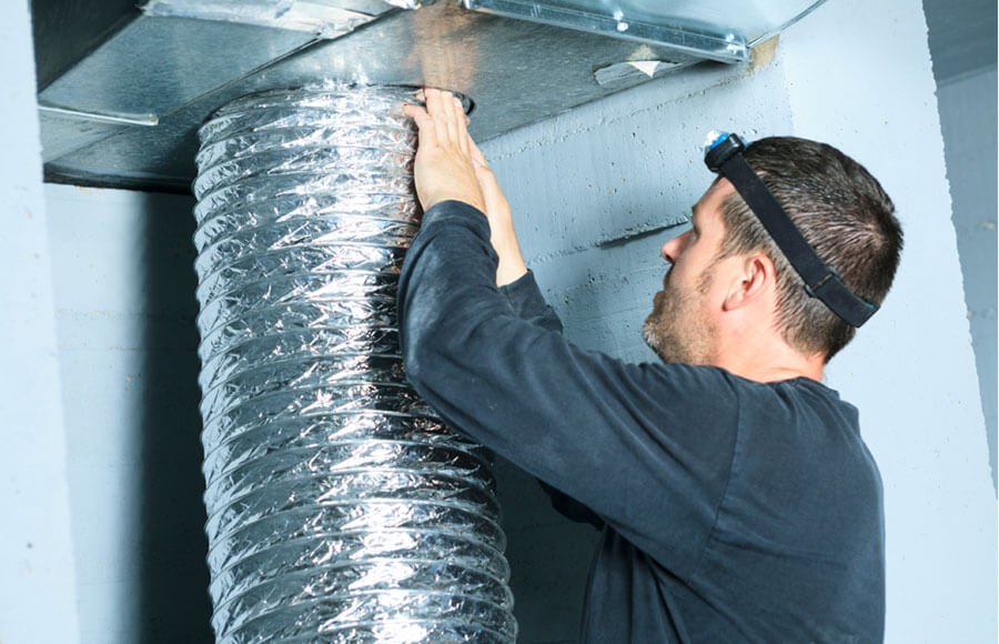 Technician working on duct